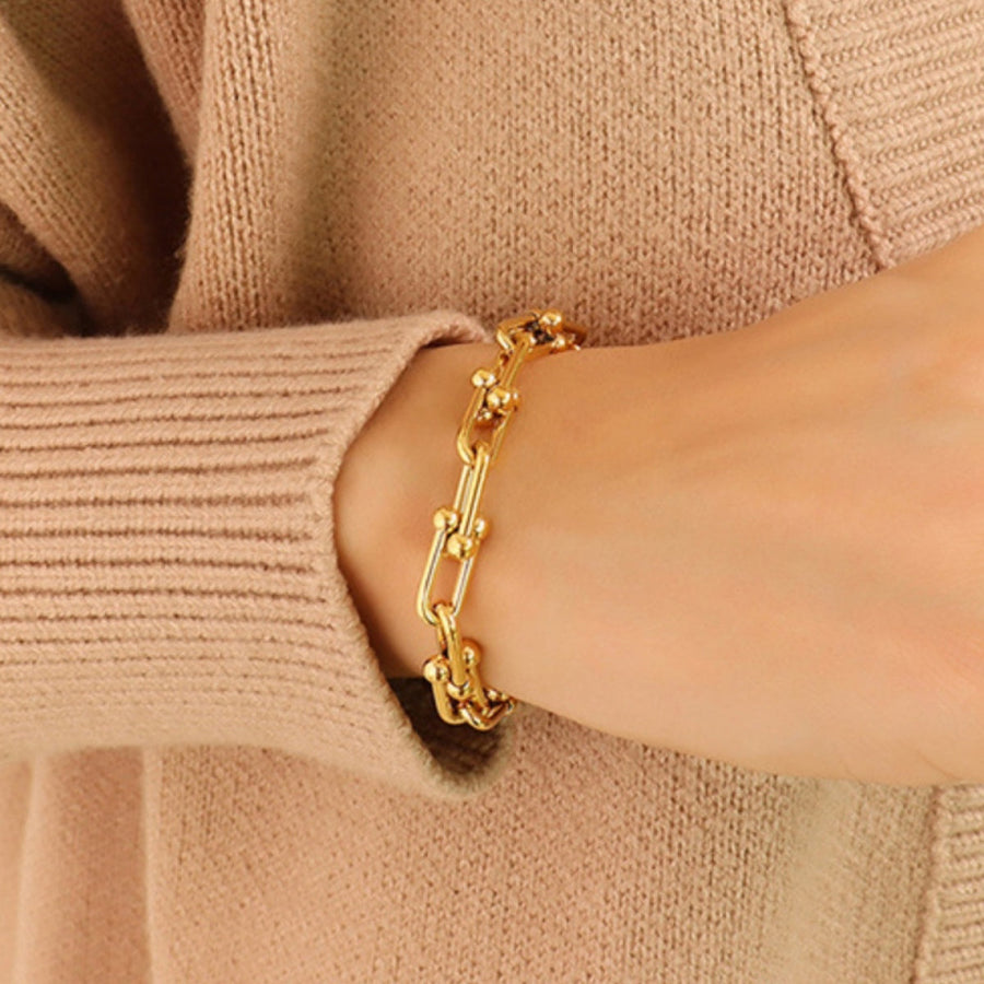 Gold sculptural link chain bracelet with small bead accents, 18k gold-plated.