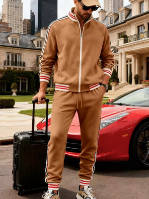Brown tracksuit with white and red striped cuffs and sleeves, zip-up jacket and jogger pants.