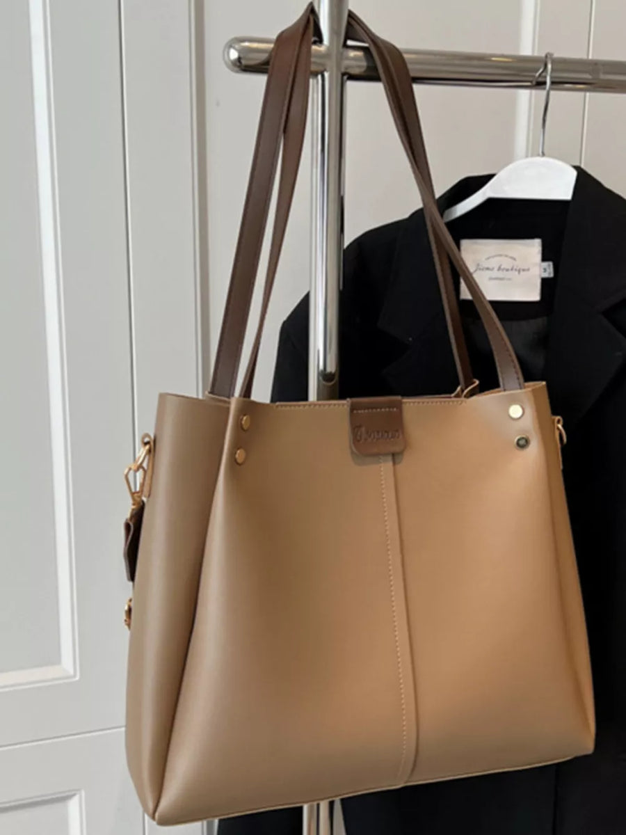 Khakis trapezoid PU leather tote bag with wide straps and detachable strap.
