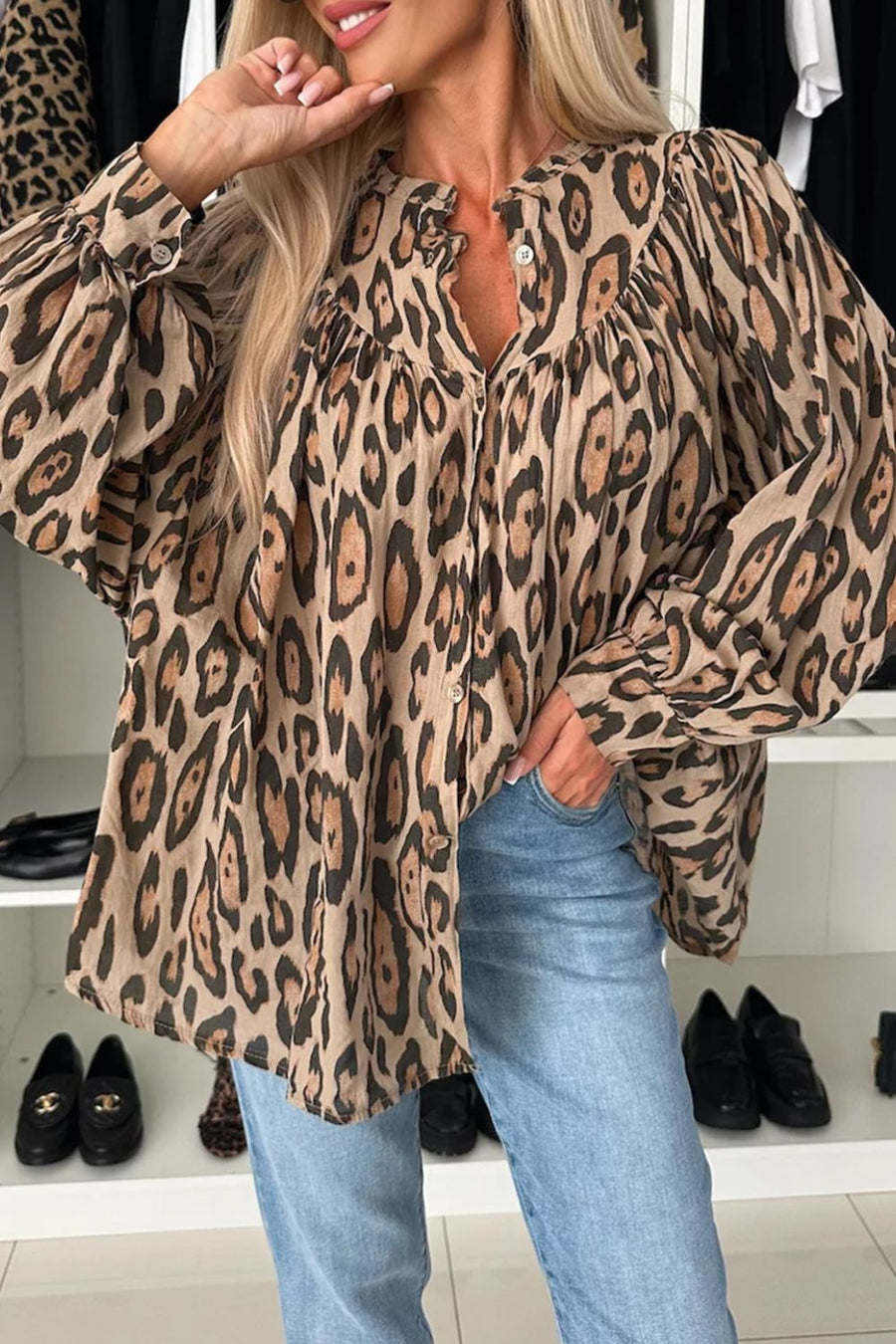 Caramel leopard print blouse with balloon sleeves and button front, styled with jeans.
