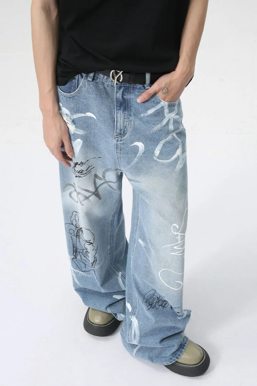 Graffiti art oversized denim trousers in medium wash with white and black abstract art print.