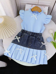 Baby blue ruffled top with white bows paired with a denim skirt with a pleated light blue hem and white bows.