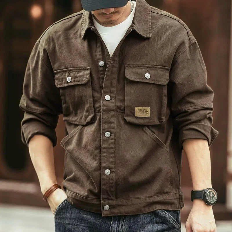 Brown washed cotton chore jacket with four front pockets and button closure.