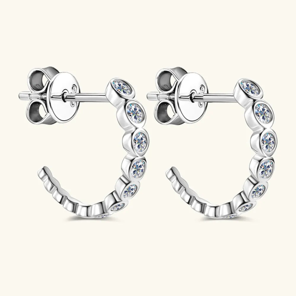 Silver moissanite pavé hoop earrings with small round cubic zirconia stones.