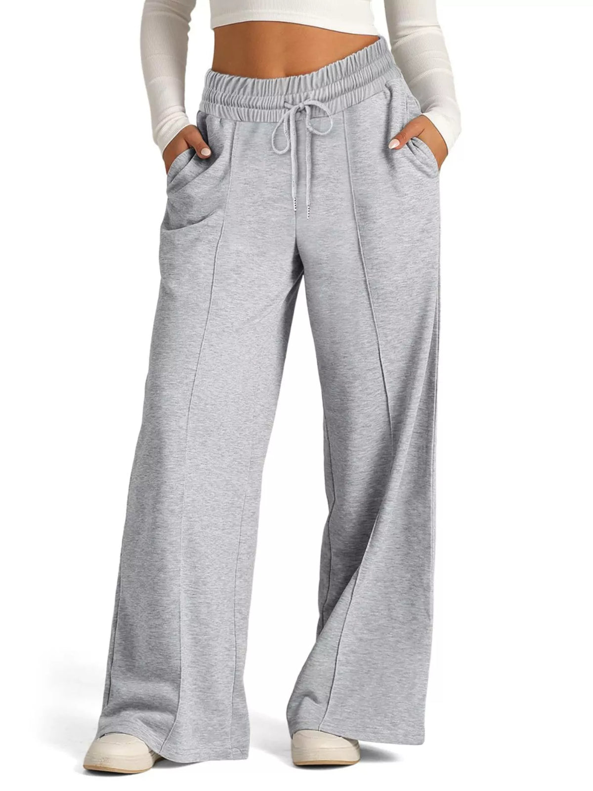 Light gray wide-leg drawstring lounge pants with front pockets and a relaxed fit.