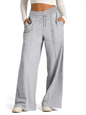 Light gray wide-leg drawstring lounge pants with front pockets and a relaxed fit.