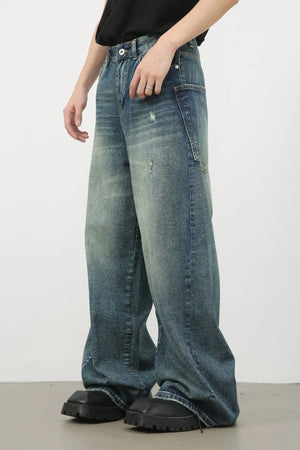 Distress denim wide leg jeans for him in medium wash with distressed details.