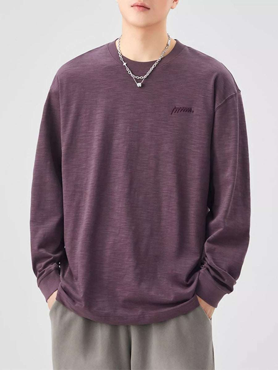 Oversized long-sleeve cotton tee in Sauce Purple with embroidered logo detail.