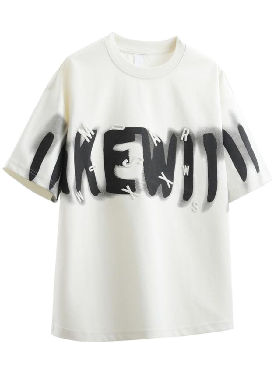 Men's oversized graphic t-shirt in white with black graffiti-style text and raised letters.