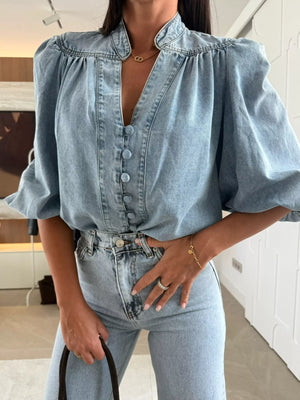 Button-down puff sleeve denim blouse in sky blue with a V-neck and gathered shoulders.