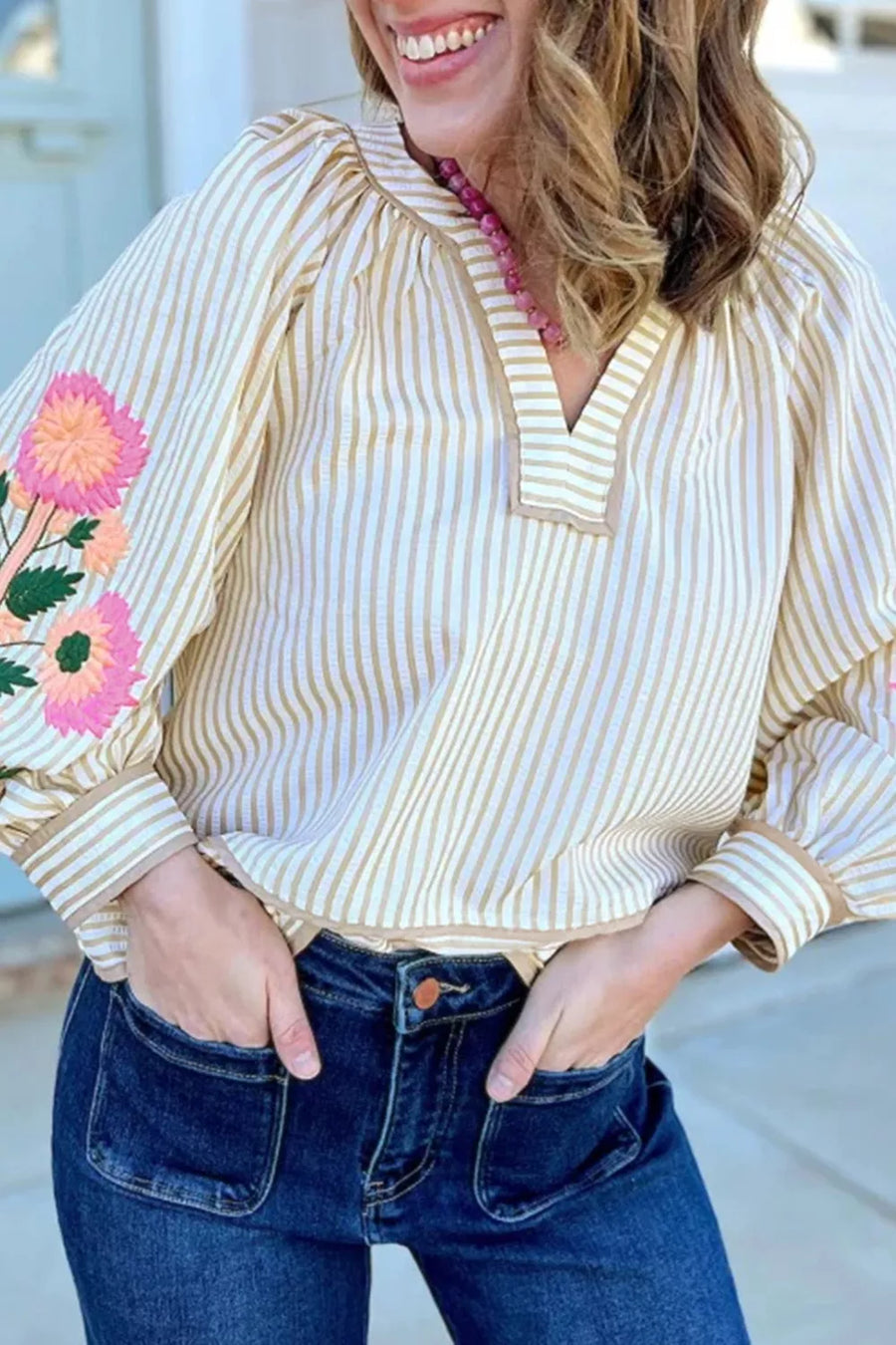 Striped blouse with embroidered floral sleeves and V-neck