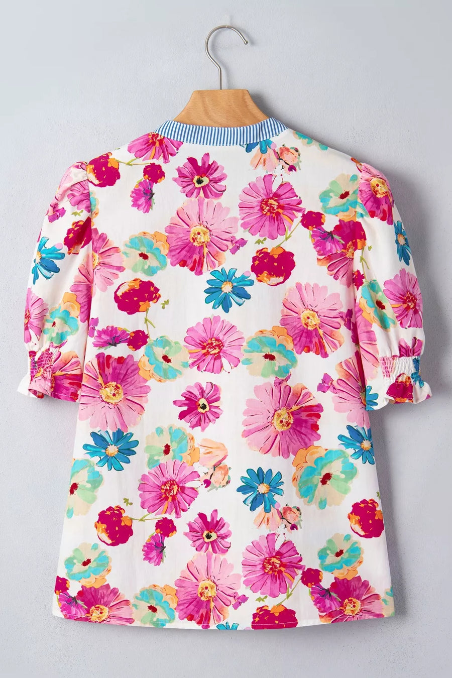 Vibrant floral print cotton blouse with blue striped collar and smocked cuffs.