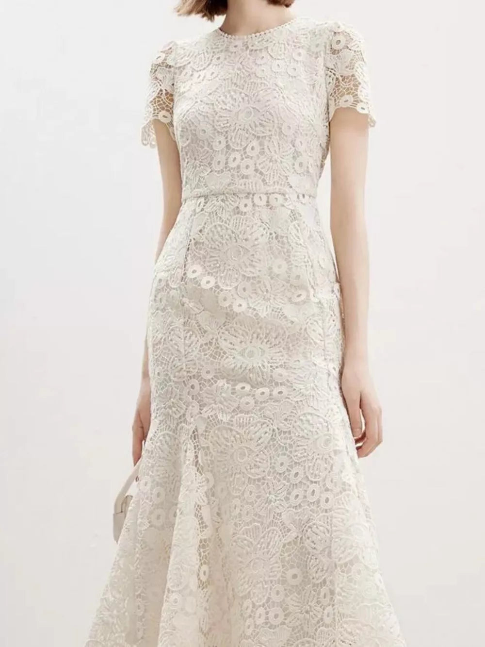 Cream floral lace mermaid gown with cap sleeves and a high neckline.