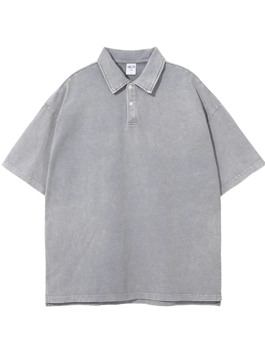Oversized gray washed polo shirt with a relaxed fit and short sleeves.