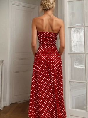 Red polka dot strapless maxi dress with a full skirt.