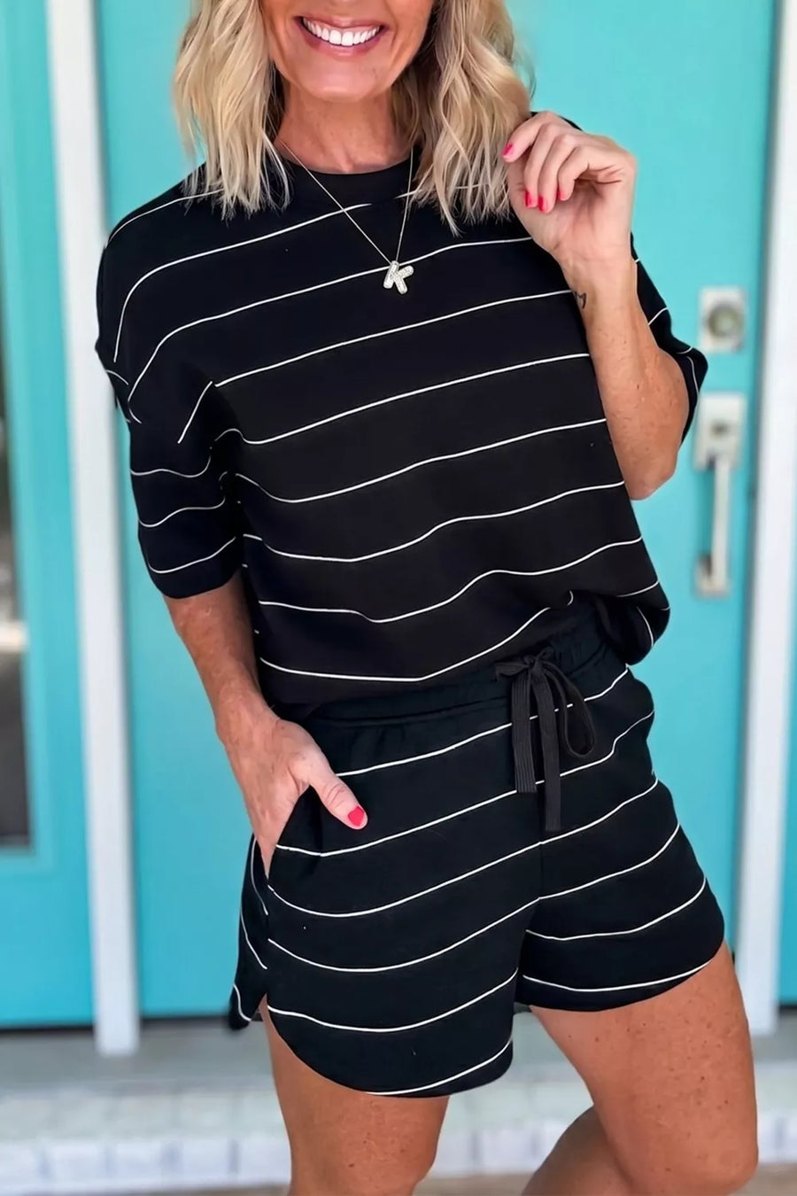 Black and white striped knit loungewear set with a crew neck top and drawstring shorts.