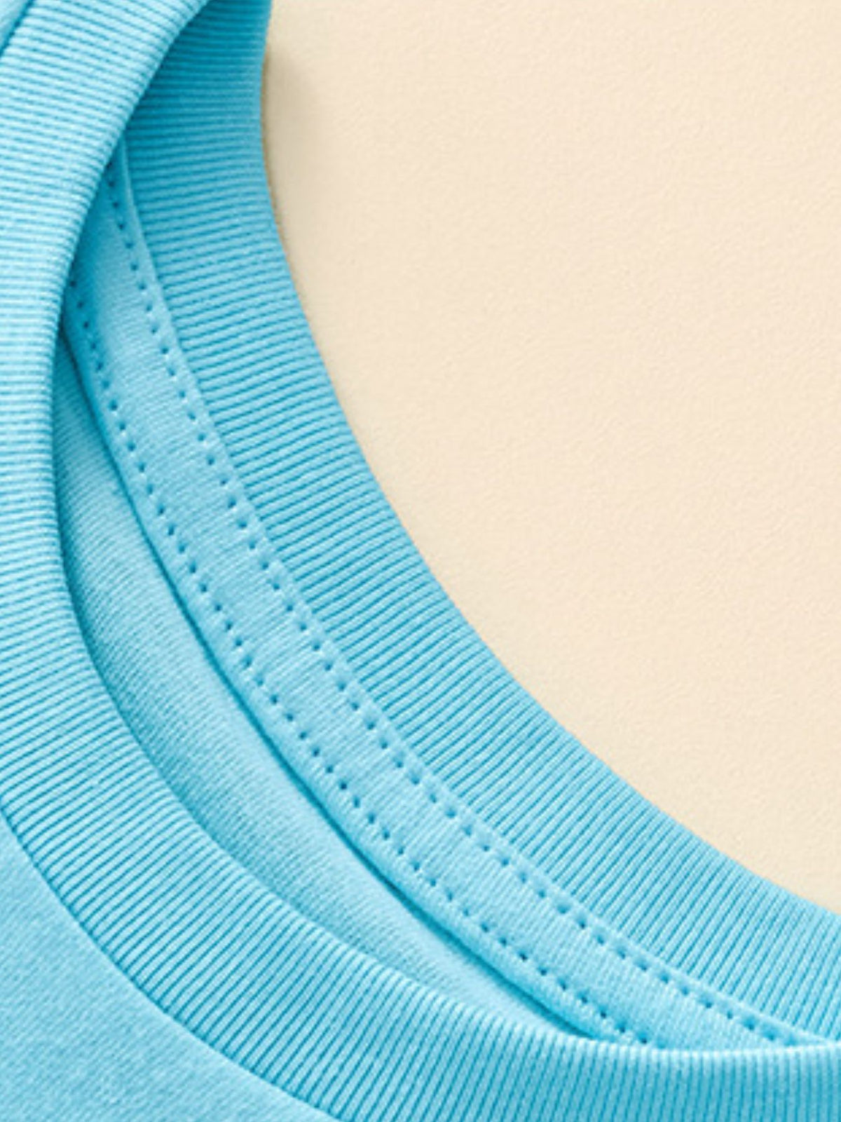 Blue cotton toddler t-shirt neckline detail with double stitching.
