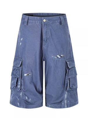 Blue faded cargo capris with distressed detailing and plaid accents.
