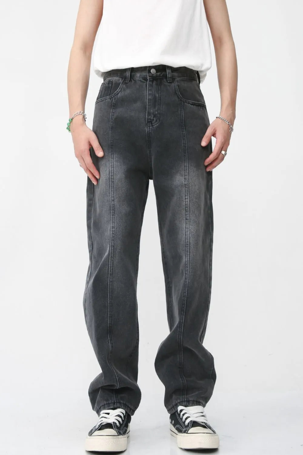 Dark wash denim jeans with vertical seam detail and a relaxed fit.