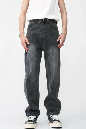 Dark wash denim jeans with vertical seam detail and a relaxed fit.
