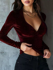 Burgundy velvet ruched long sleeve t-shirt with subtle sparkle detail and deep V-neck.