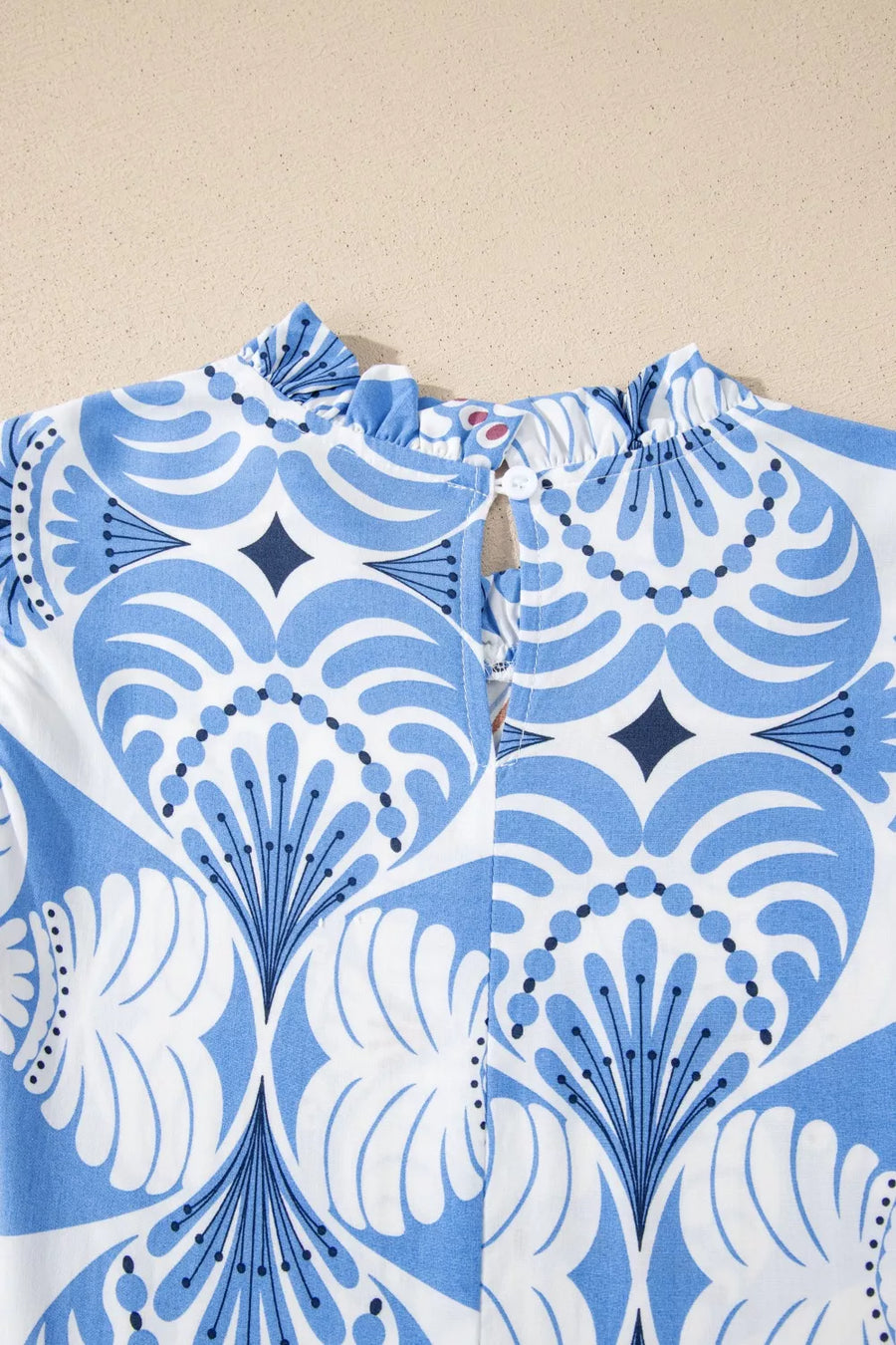 Botanic print ruffled mock neck dress with flutter sleeves and a keyhole back detail.