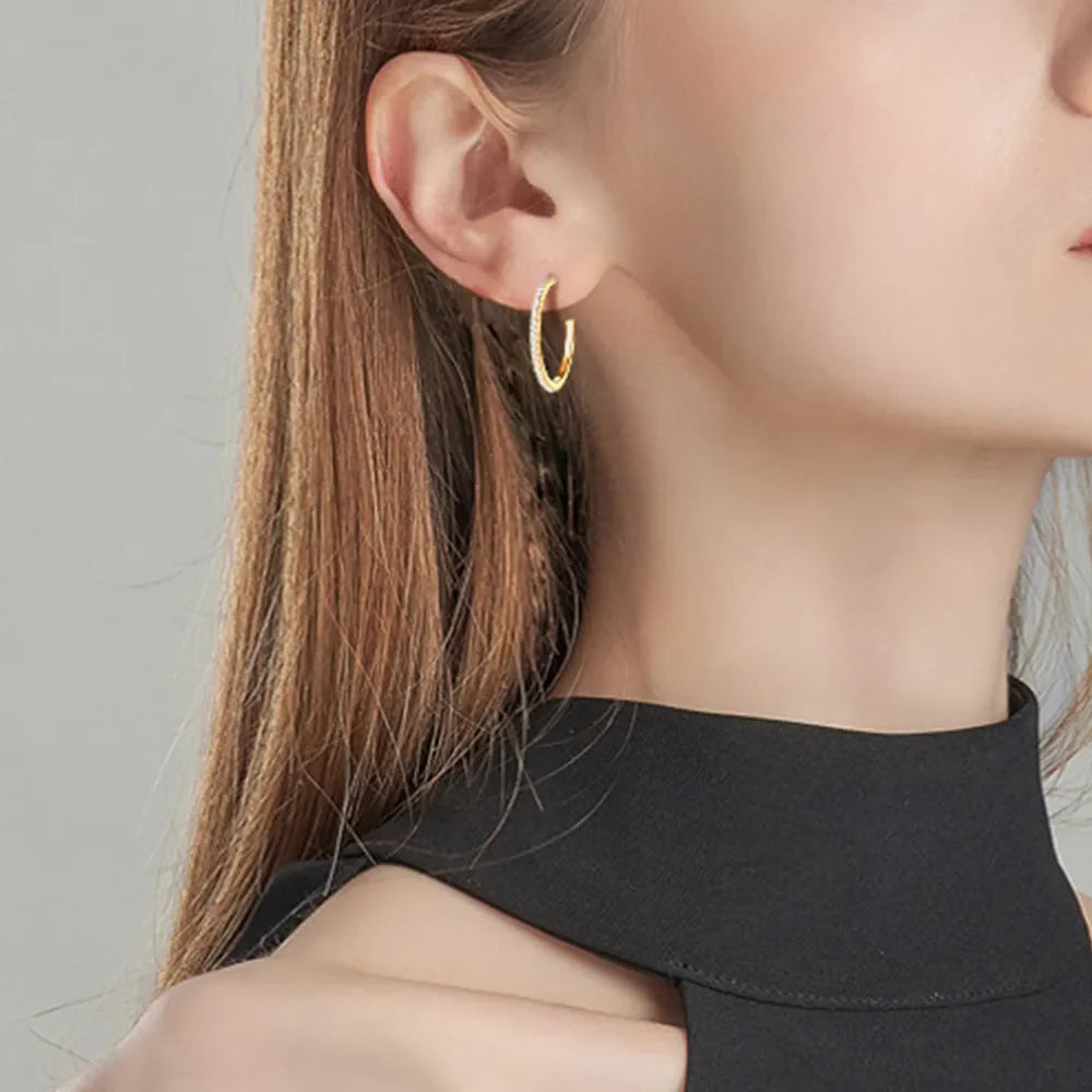 Gold C-hoop earrings with pavé-set stones, 18K gold-plated.