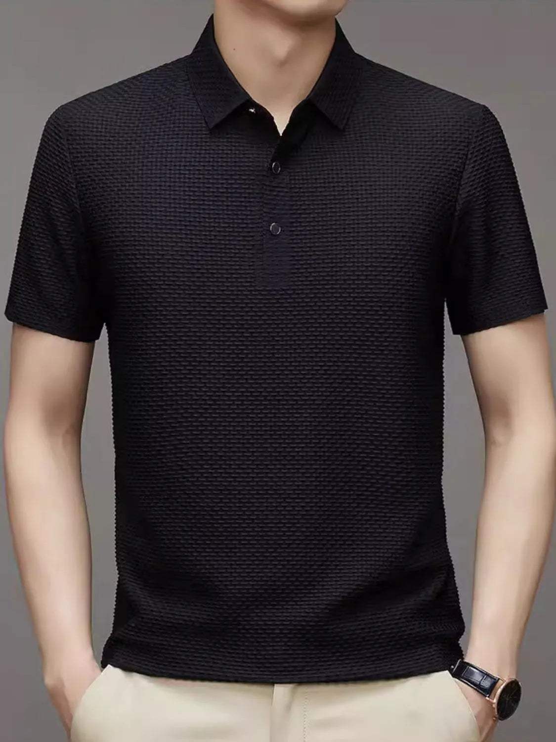 Black textured knit polo shirt with short sleeves and a two-button placket.