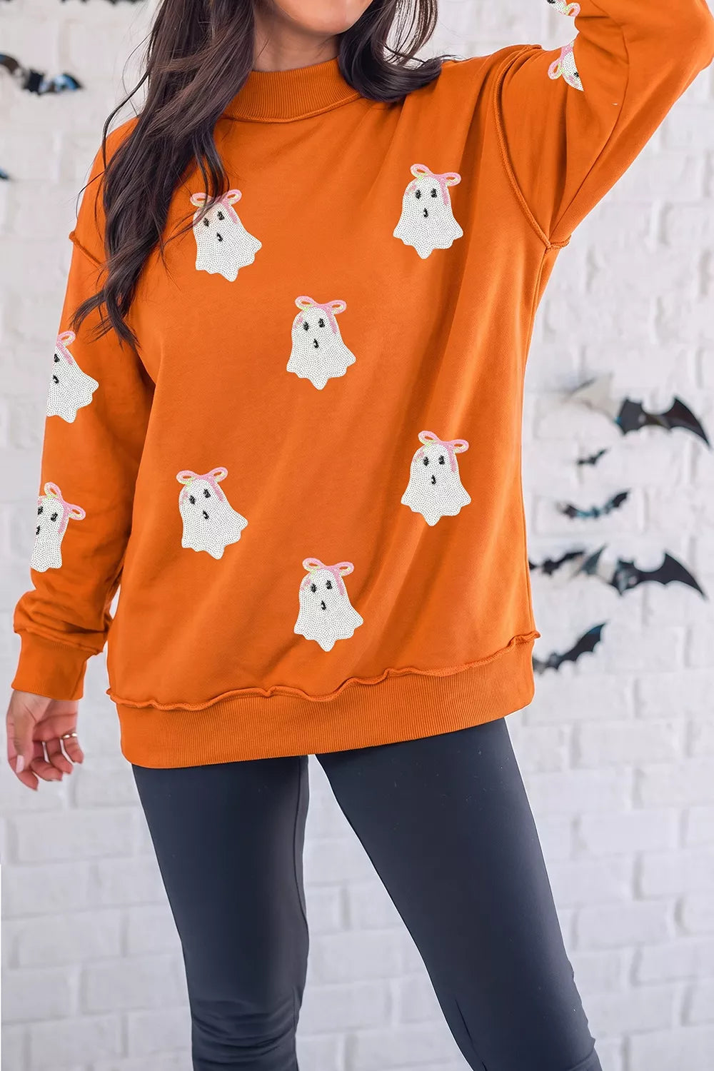 orange sweatshirt with ghost and mock neck