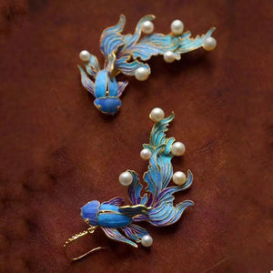 Blue enamel goldfish dangle earrings with pearl accents, 18K gold-plated.