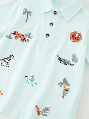 Light blue baby polo shirt with embroidered jungle animals and palm trees.
