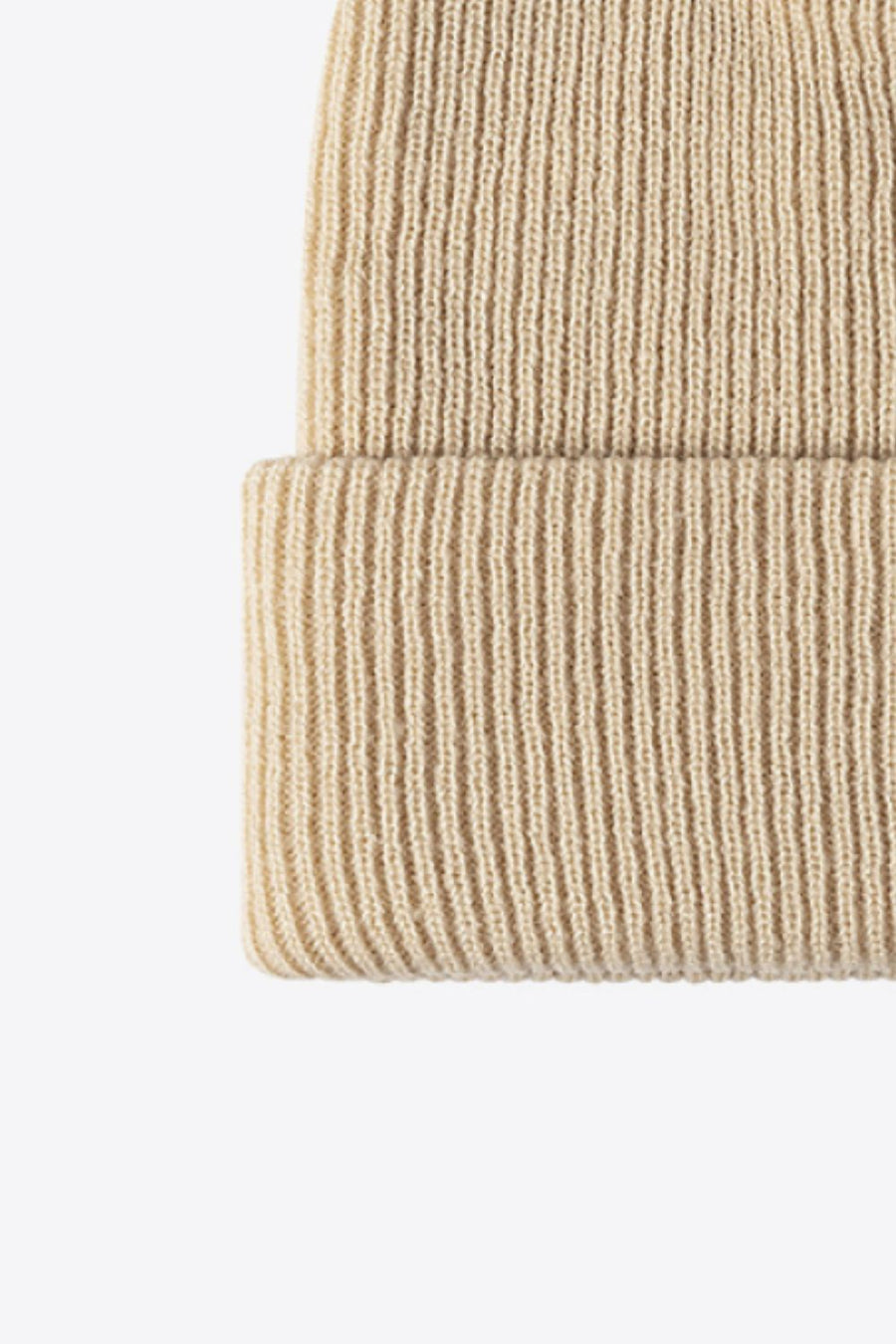 Beige ribbed knit beanie with a cuffed hem.