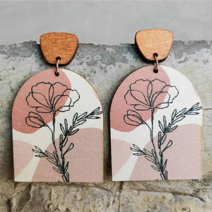 Botanical arch wood earrings in dusty pink with floral line art and boho abstract shapes.