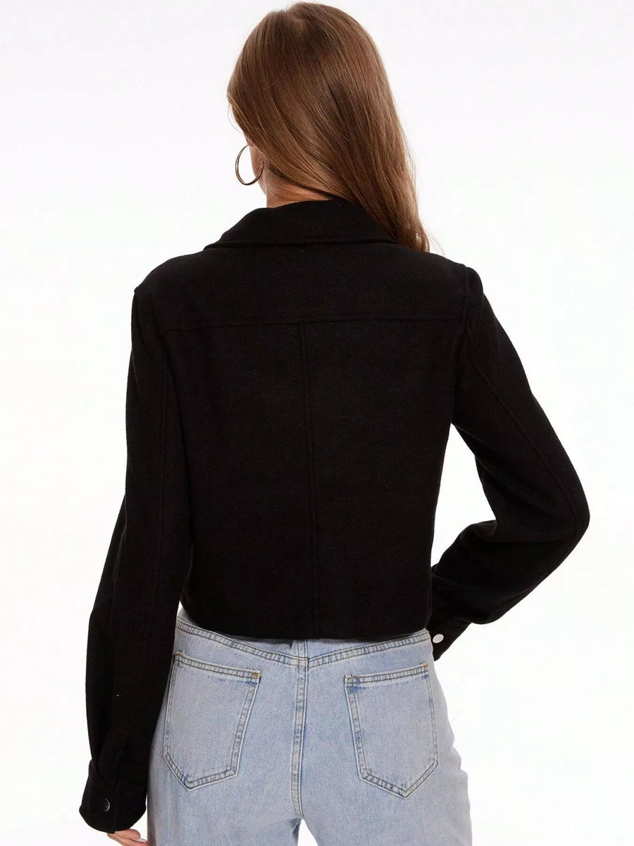 Black trucker jacket with snap buttons and long sleeves, shown from the back.