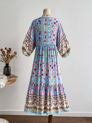 Plus-size light blue floral v-neck dress with tiered hem and bohemian print sleeves.