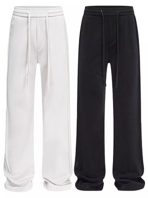 Relaxed fit drawstring casual pants in light gray and black with a cotton blend material.