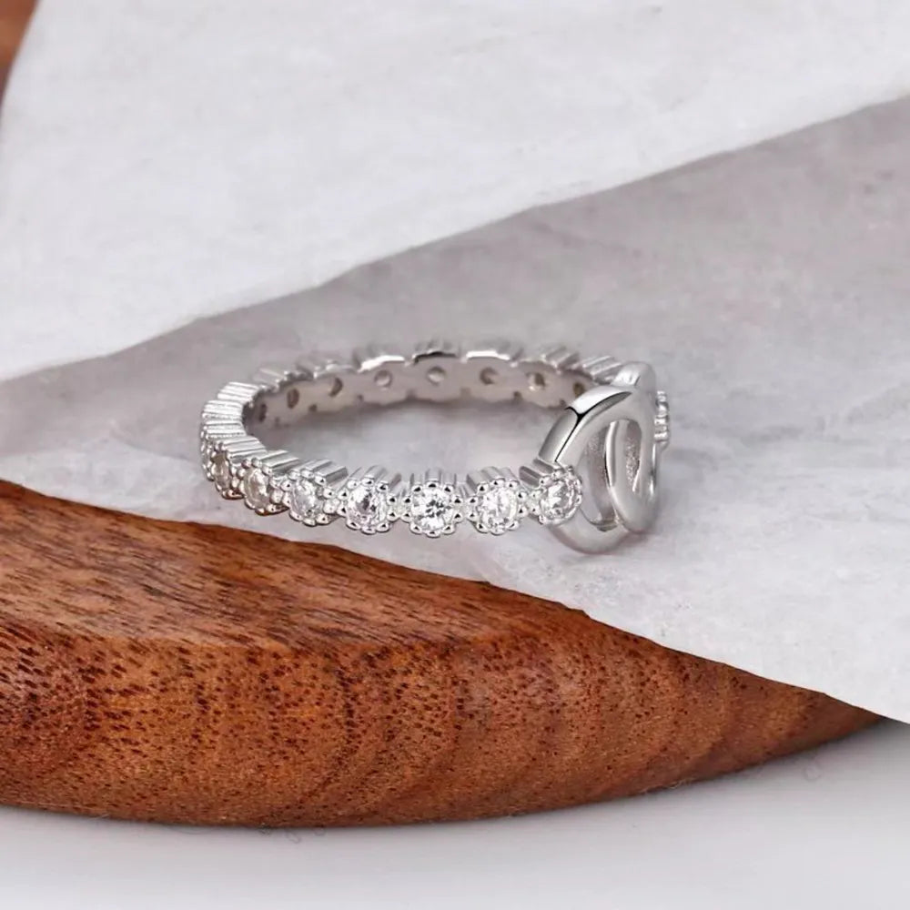Silver pavé eternity ring with interlocking detail.