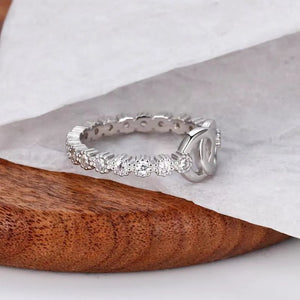Silver pavé eternity ring with interlocking detail.