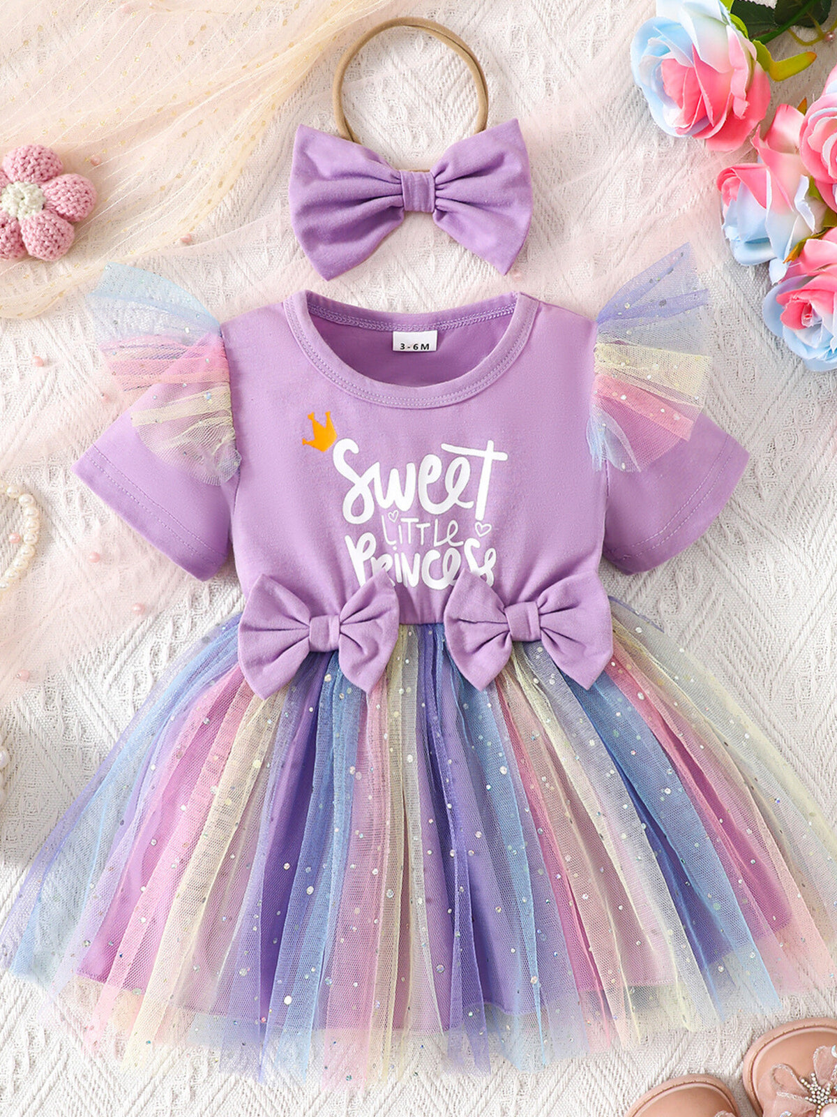 Lavender baby dress with rainbow tulle skirt, two bows, and matching headband.