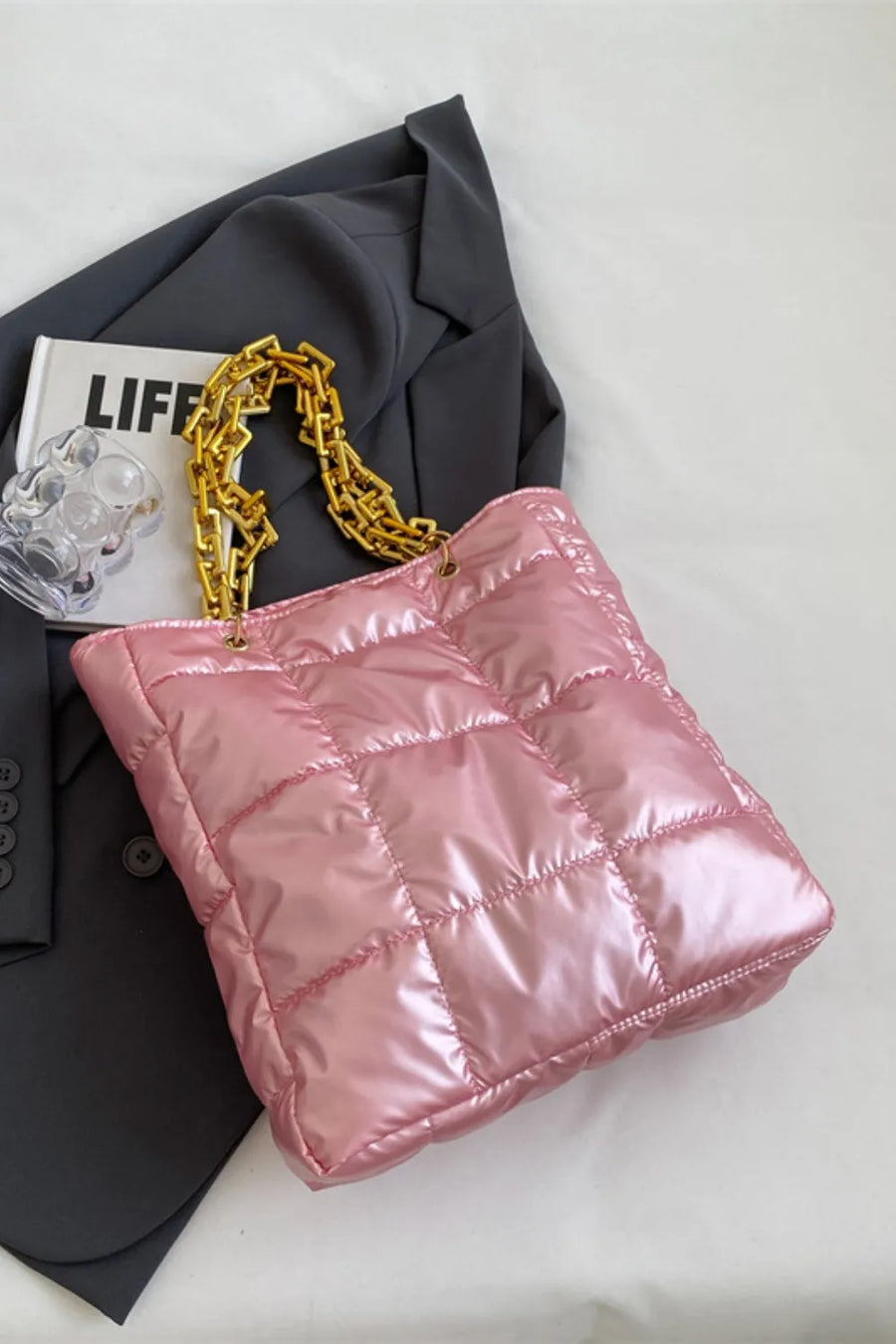 Pink quilted nylon tote bag with gold chain handle