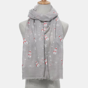 Light gray scarf with a festive snowman and snowflake print, frayed hem.