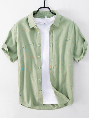sage green button-up shirt with paint splatter and collared
