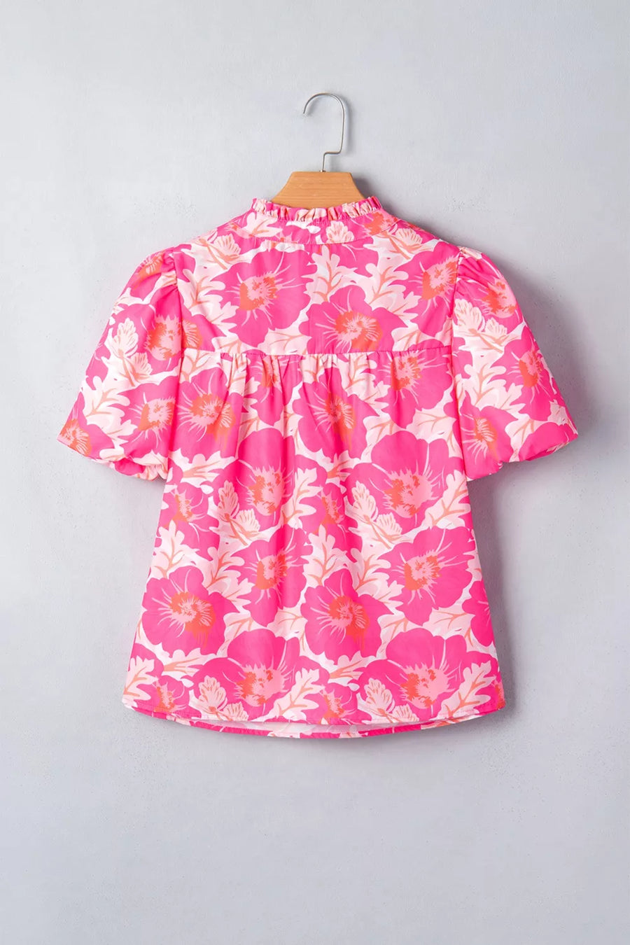 Vibrant floral polyester blouse with ruffled mock neck and bubble sleeves.