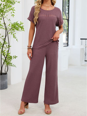 Plum purple lace cutout two-piece set with wide leg pants and short sleeve top.