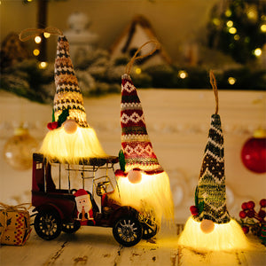 Illuminated gnome ornaments with knitted hats in various patterns and fluffy white beards.