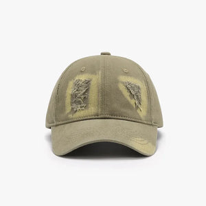 Distressed denim baseball cap in Army Green with ripped patches and yellow undertones.