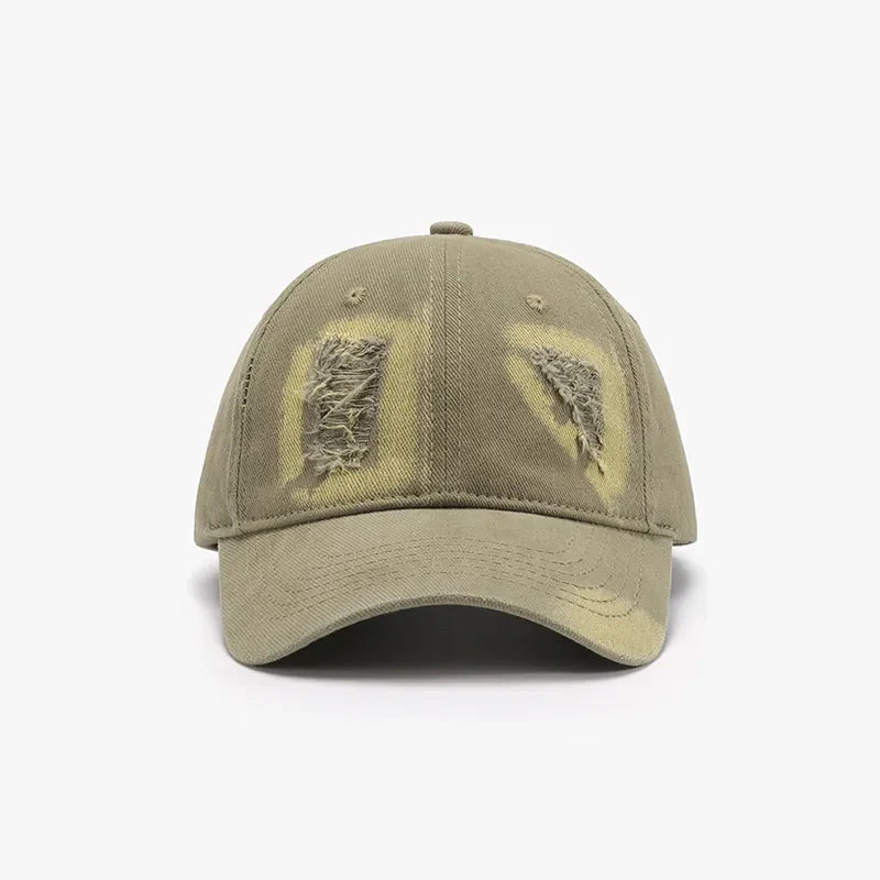 Distressed denim baseball cap in Army Green with ripped patches and yellow undertones.