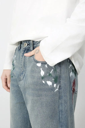 Ink-Blot Wide Leg Denim jeans in medium wash with abstract paint splatters.