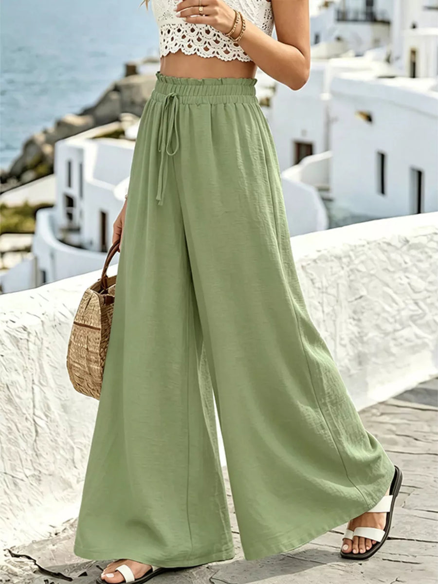 Wide leg pants in light green with drawstring waist and ruffled detail.