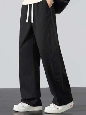 Men's Plus Size Pocketed Drawstring Wide Leg Pants in Black with drawstring waist